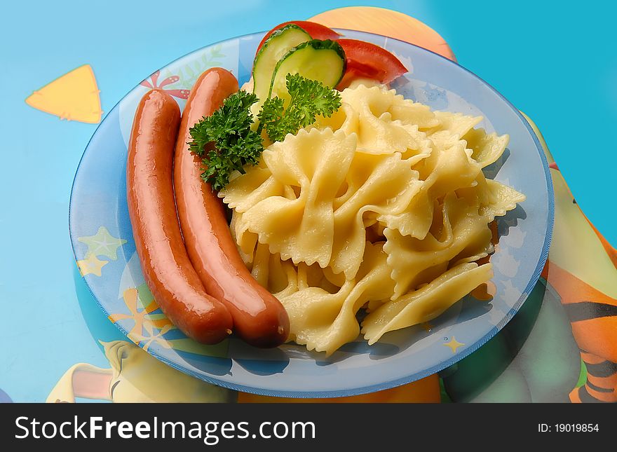 pasta with sausage and vegetables on the plate