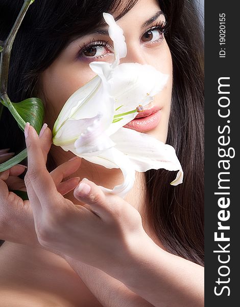 Beautiful young woman with fresh clean skin and white flower. Beautiful young woman with fresh clean skin and white flower