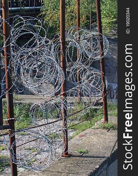 Metal fence with barbed wire