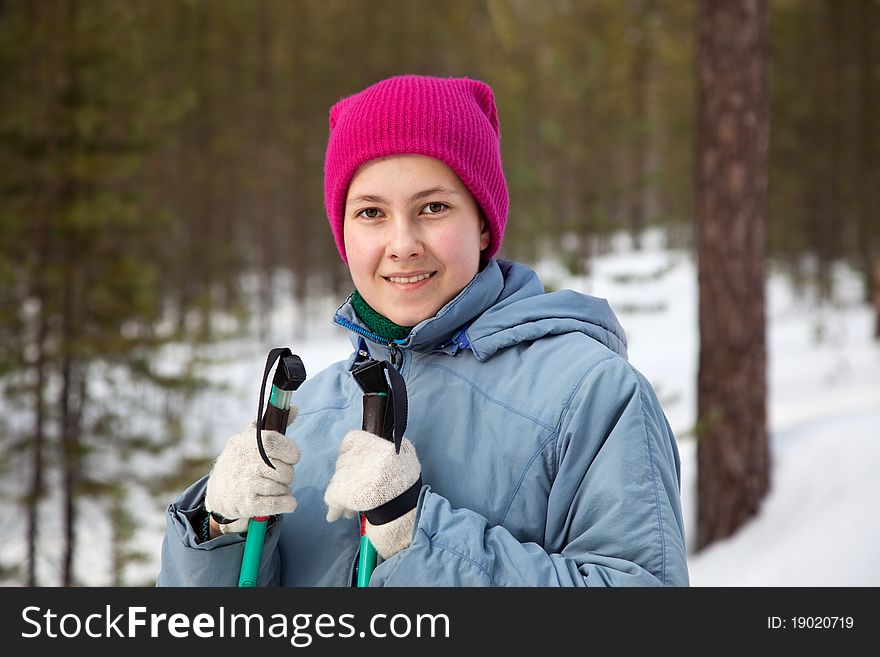 A young girl on a ski outing against the backdrop of the winter forest. A young girl on a ski outing against the backdrop of the winter forest