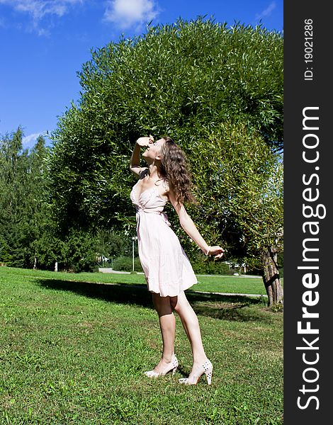 Beautiful Young Happy Woman Under Blue Sky.