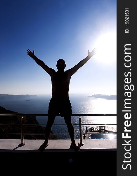 Young man admires the sunset in Santorini, Greece. Young man admires the sunset in Santorini, Greece