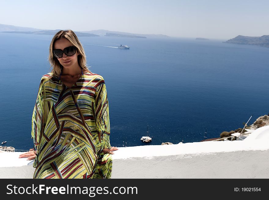 Happy woman in the wind in santorini