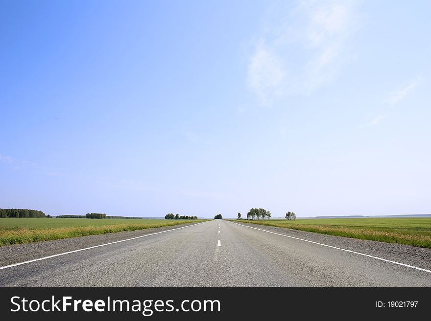 Asphalt road with a dividing strip. Asphalt road with a dividing strip