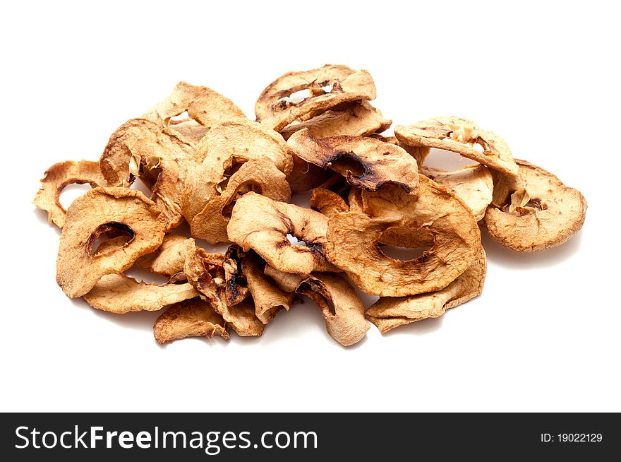 Dried apple slices over a white background