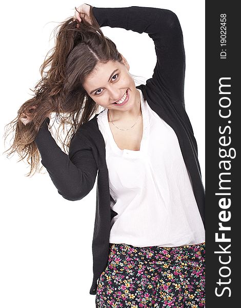 Young and smiling girl having fun and pulling her long hair