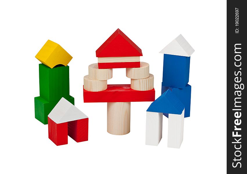Several houses collected from children's wooden blocks. Isolated on white background. Several houses collected from children's wooden blocks. Isolated on white background.