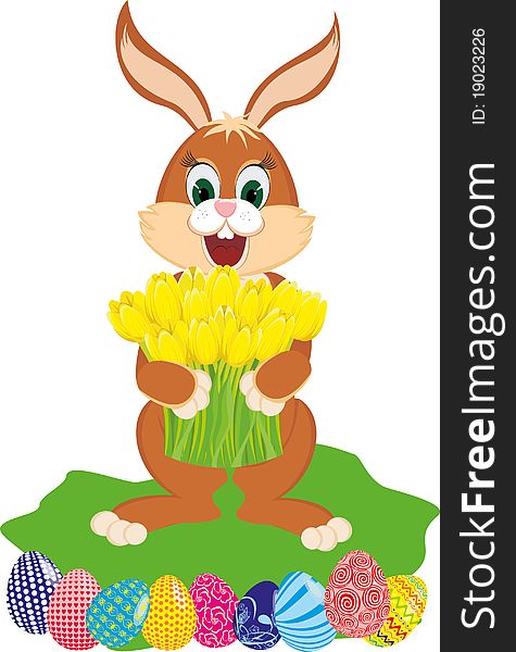 Easter rabbit with spring flowers yellow tulips and the colored eggs