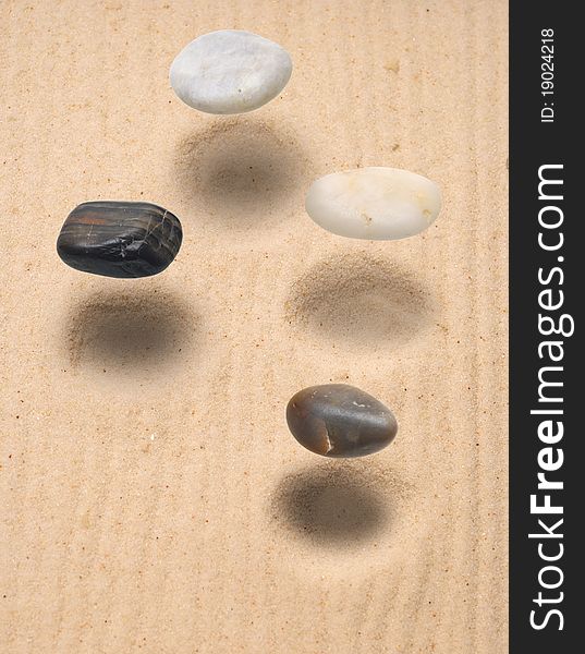 Levitation four stones over sand. Levitation four stones over sand