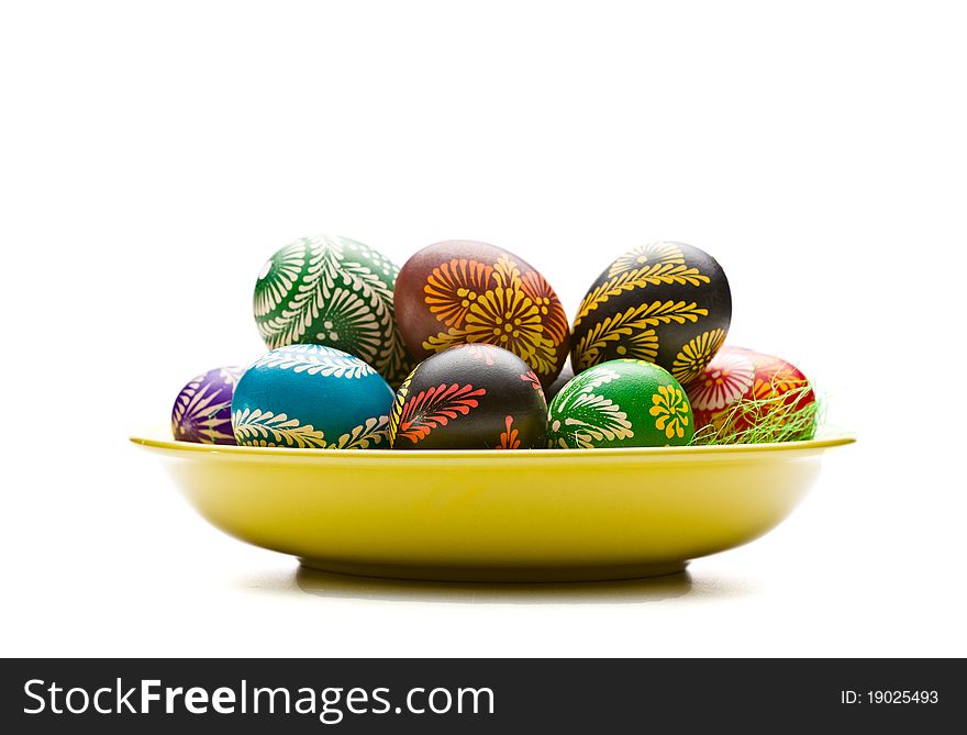 Painted Easter eggs on yellow plate. Painted Easter eggs on yellow plate