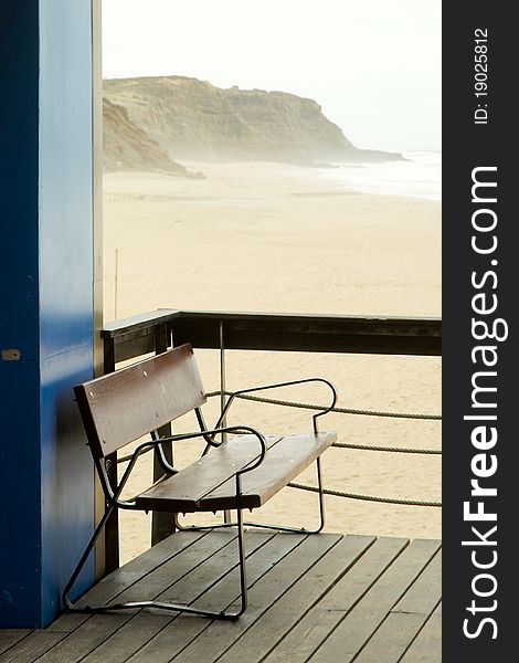 Empty bench at empty beach