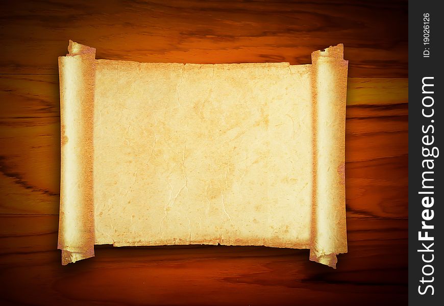 An ancient paper with torn edges, on a brown wooden surface. An ancient paper with torn edges, on a brown wooden surface