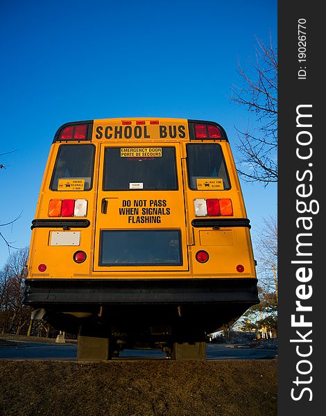 A view of a traditional yellow school bus from the rear. A view of a traditional yellow school bus from the rear.