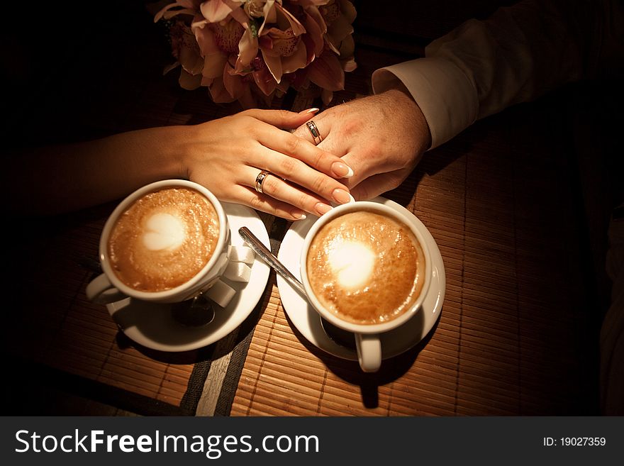 Woman's hand on man's with golden rings. Woman's hand on man's with golden rings