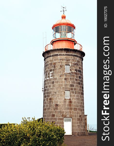 Stone build lighthouse with orange top in Granville France.