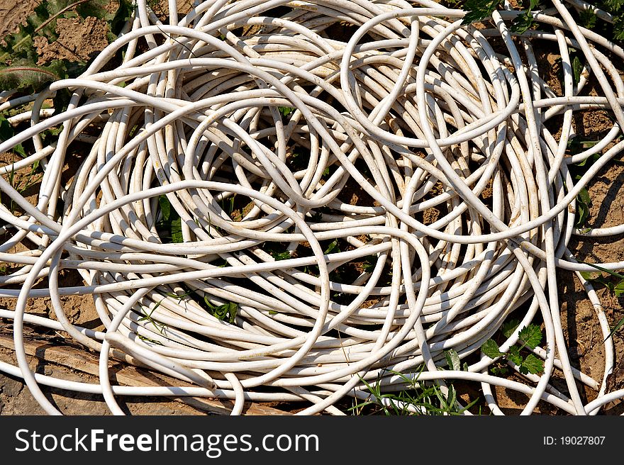 Big coil of electrical wire lying on the ground