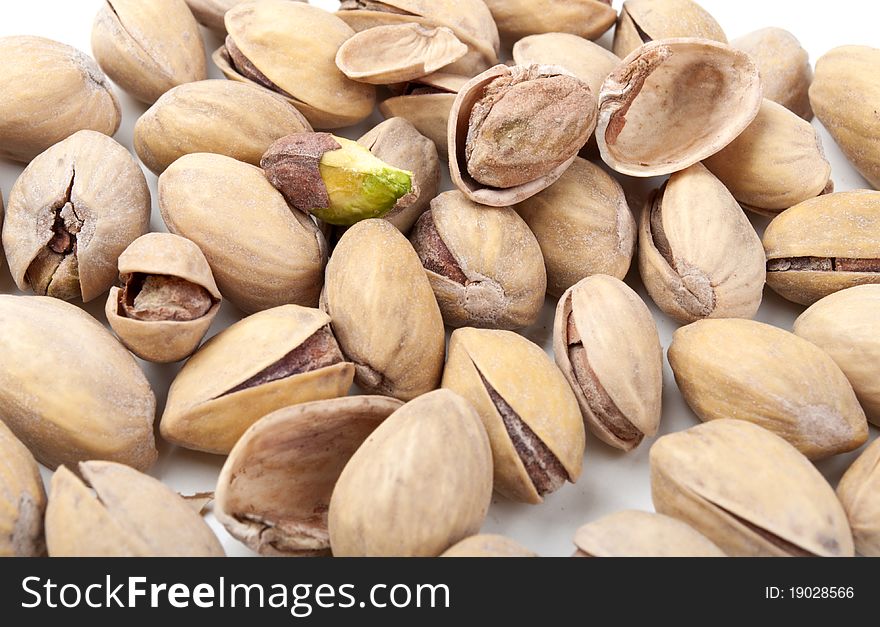 Many pistachios isolated on a white background