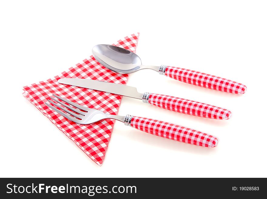Modern red white checkered cutlery with a napkin isolated on white background
