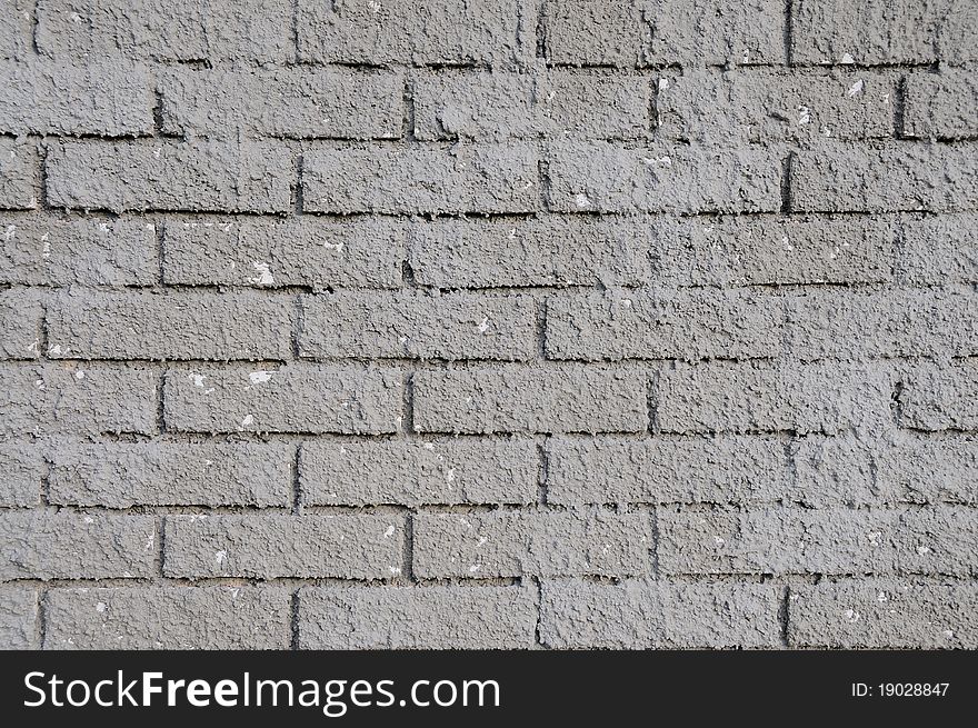 Unfinished brick wall with fresh concrete on it