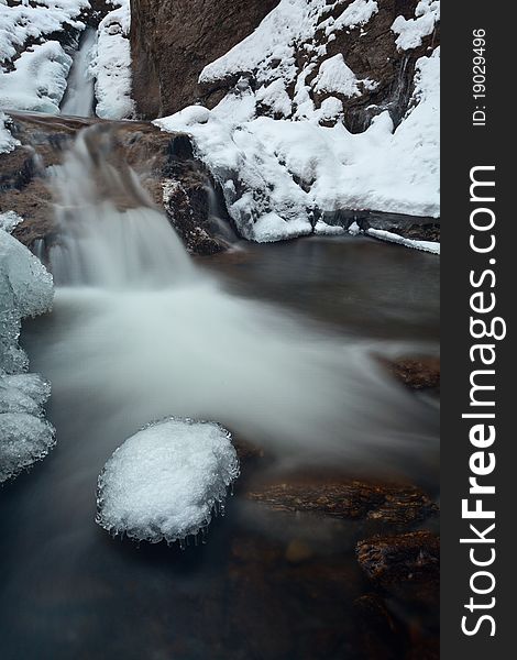 Mountain waterfall with some some at the end of winter. Mountain waterfall with some some at the end of winter