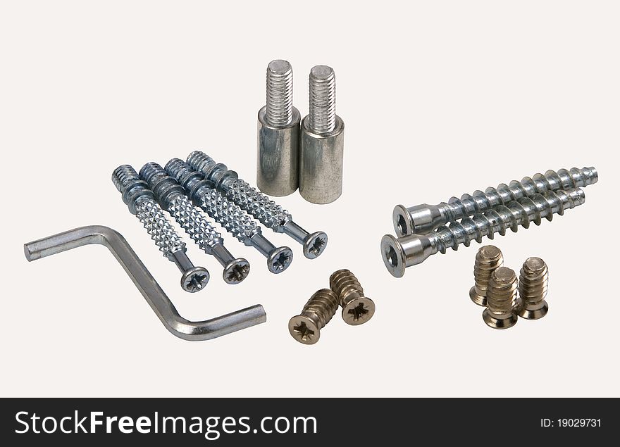 Set of modern bolts and screws for furniture assemblage, isolated on white.