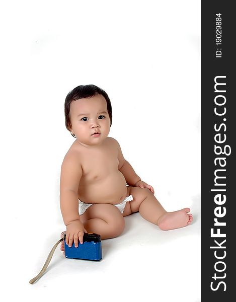 a chubby little girl sit with a vintage camera isolated on white background