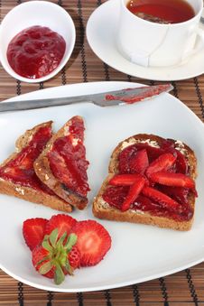 Toast With Strawberry Jelly And Tea Stock Images