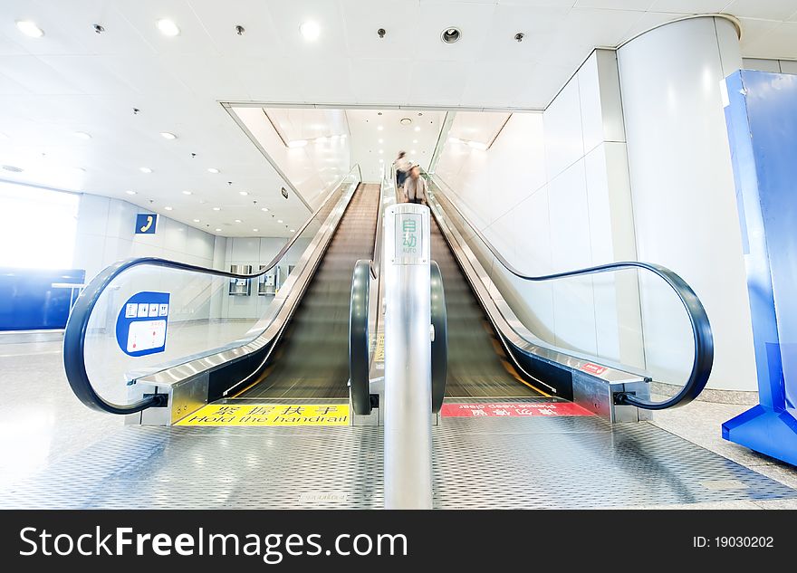 People at the airport escalator