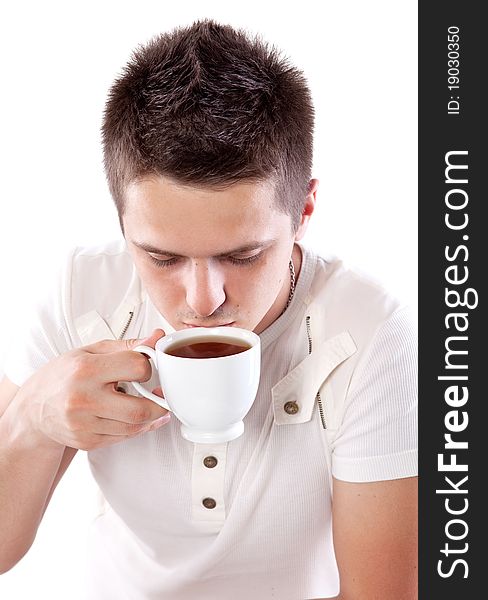 Young man with fresh cup of black tea. Young man with fresh cup of black tea