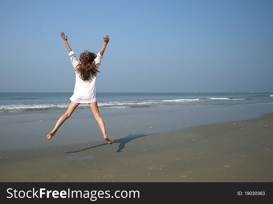 Woman on the beach near sea and blue sky