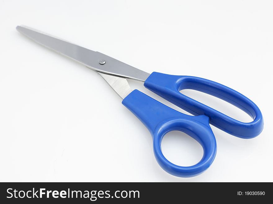 Close up of blue handle scissors on white background. Close up of blue handle scissors on white background