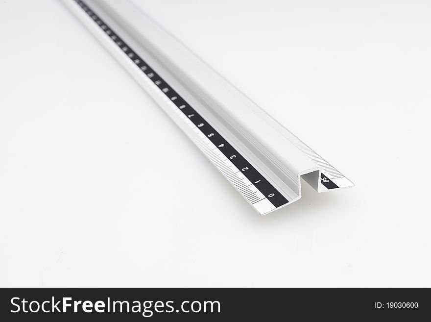 Close of a grey ruler on white background