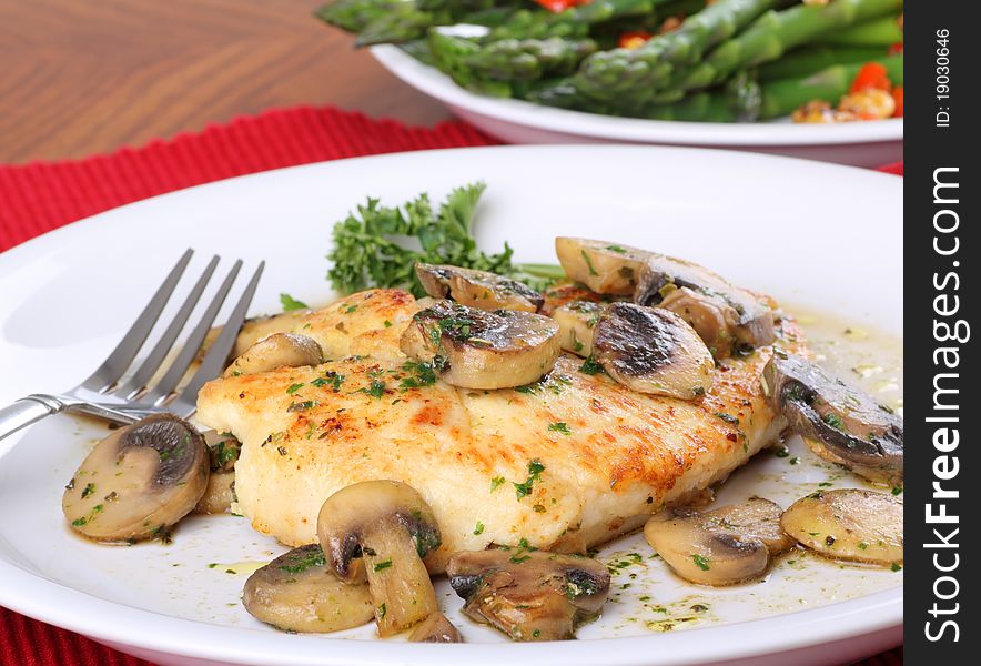 Fried chicken breast covered with a mushroom sauce. Fried chicken breast covered with a mushroom sauce