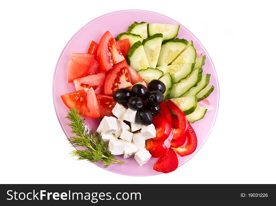 Plate of fresh cut vegetables across white