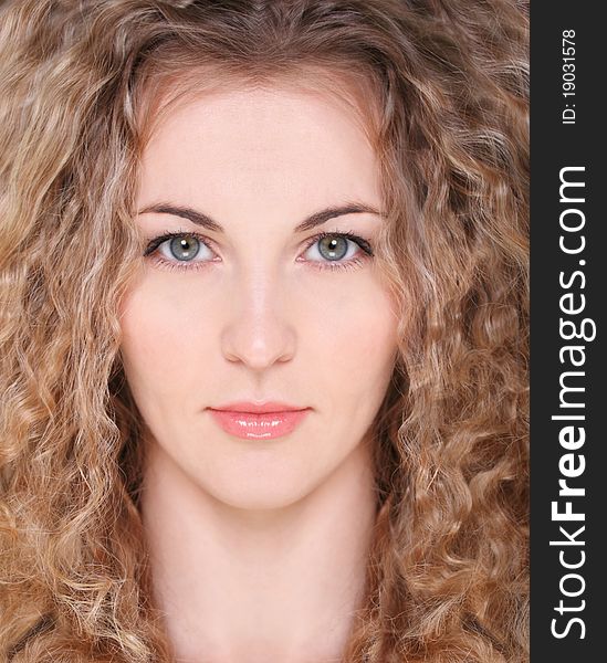 Portrait of the beauty young blond girl with curly hair. Portrait of the beauty young blond girl with curly hair