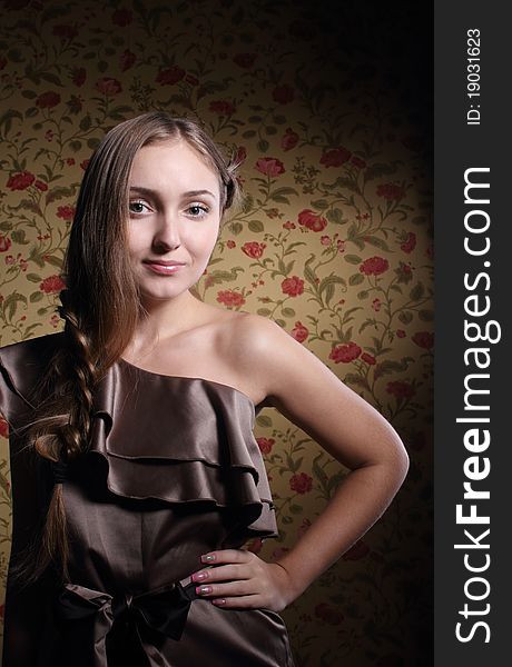 Portrait of the beauty young blond girl near the wall with roses