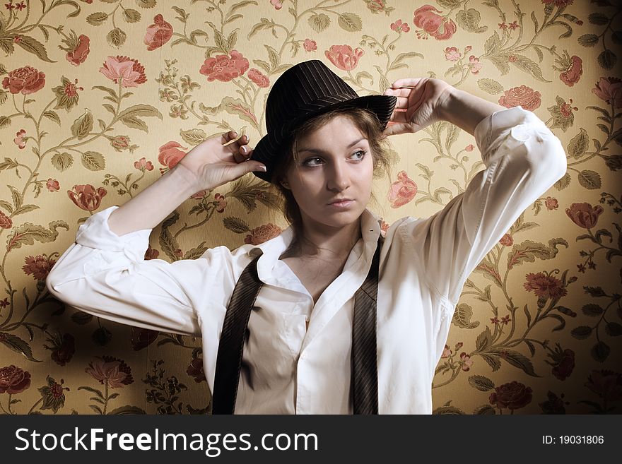 Portrait of the beautiful stylish brunette girl in hat