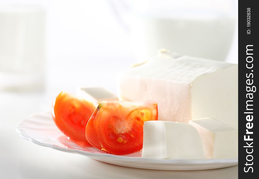 Slices of tomato and feta cheese on isolated