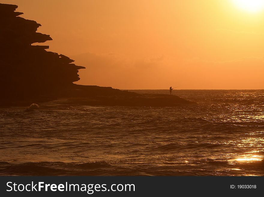 Fisherman At Sunset In Silhouette