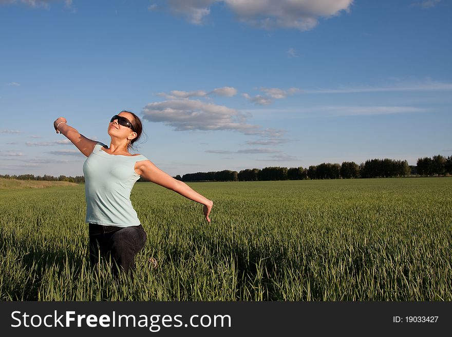 Young woman relaxing at green grass field