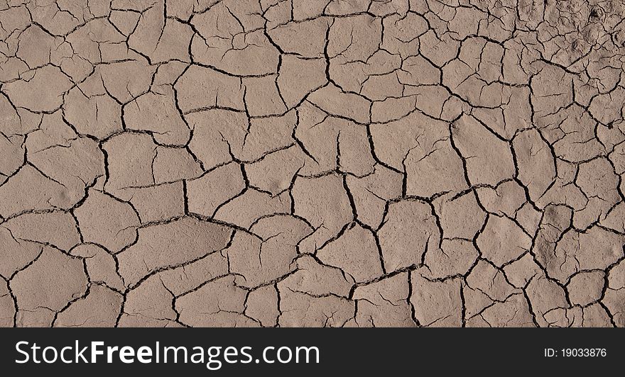 Brown clacked and dry desert soil closeup. Brown clacked and dry desert soil closeup