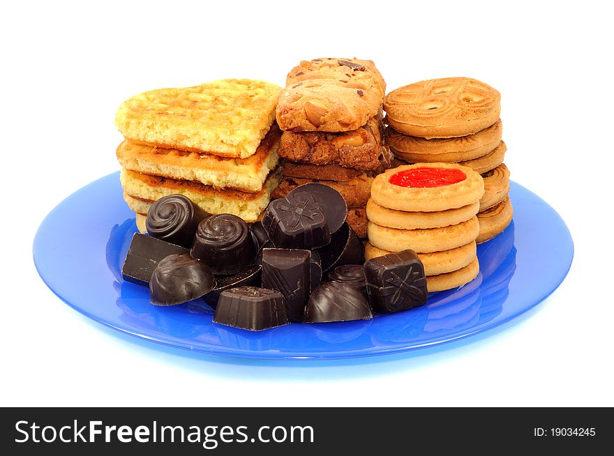 Chocolat and cookies on the plate on a white background. Chocolat and cookies on the plate on a white background