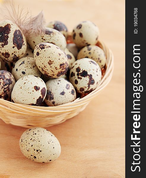 Quail eggs in the basket with the plumelet