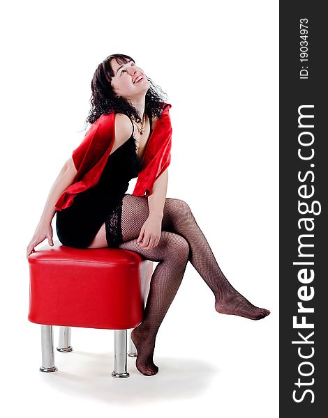 Woman in stockings sitting on red banquette