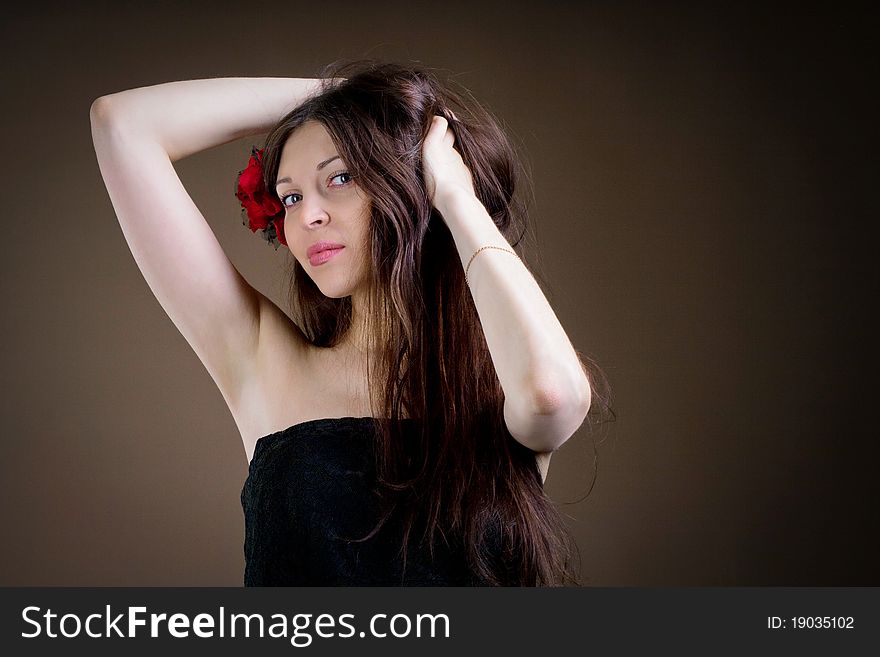 Portrait of attractive woman with flower in hair