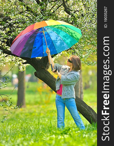 Beautiful woman with umbrella in rainbow colors