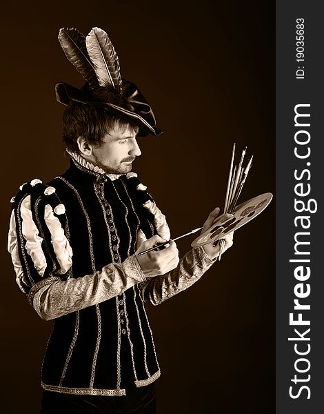 Portrait of a handsome man artist in 16th century costume. Shot in a studio. Portrait of a handsome man artist in 16th century costume. Shot in a studio.