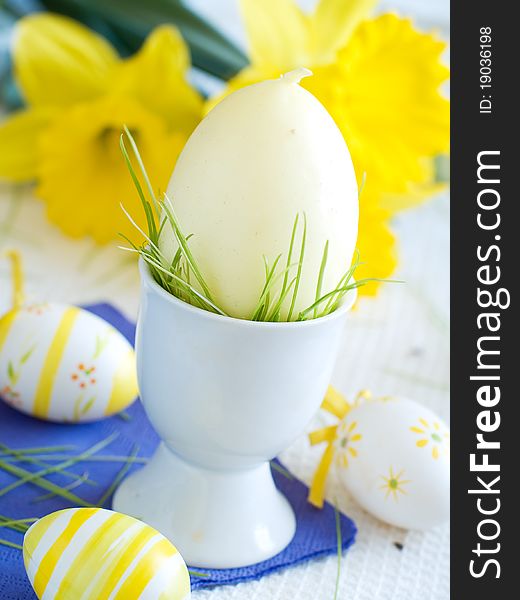 Easter Eggs in eggcup with flower on background