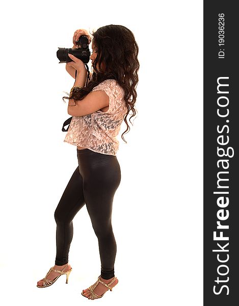 Young pretty Asian woman taking pictures with her camera, in black
tights and beige blouse, standing in the studio for white background. Young pretty Asian woman taking pictures with her camera, in black
tights and beige blouse, standing in the studio for white background.