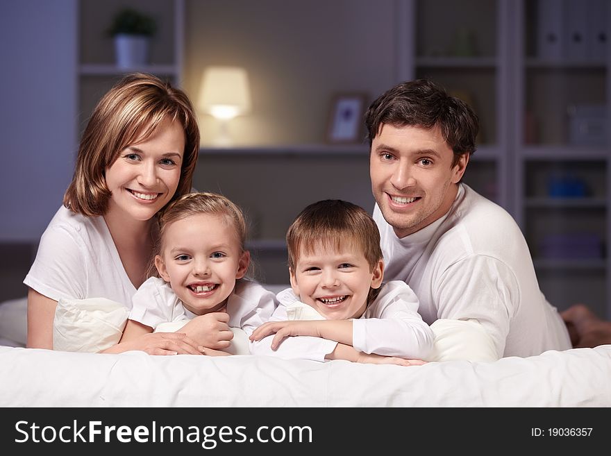 Young family with kids at night in the bedroom. Young family with kids at night in the bedroom